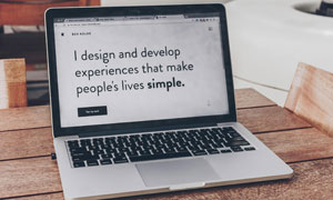 geöffneter Laptop mit einem geöffneten Browser-Tab, auf dessen Seite steht: "I design and develop experiences that make people's lives simple."